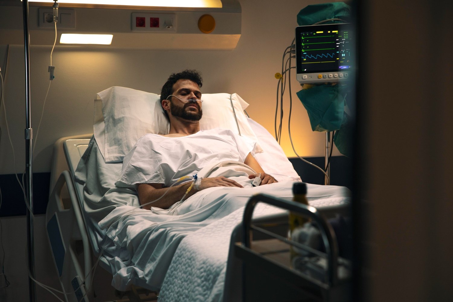 young man being ill hospital bed